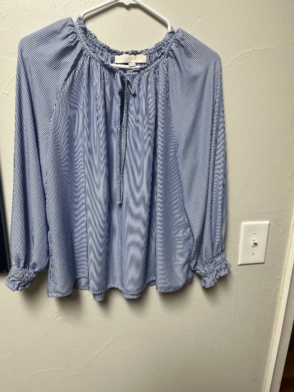 LOFT blue and white striped tie neck blouse with back hem ruffle
